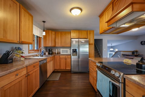 Bright, spacious kitchen with stainless appliances and generous counter space