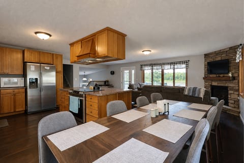 Spacious open kitchen, dining & cozy living area with fireplace views