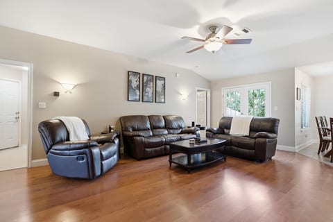 Bright open living room with leather seating and vaulted ceilings