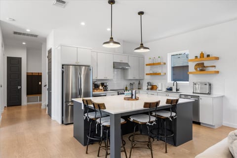 Bright modern kitchen with island seating for four and sleek finishes