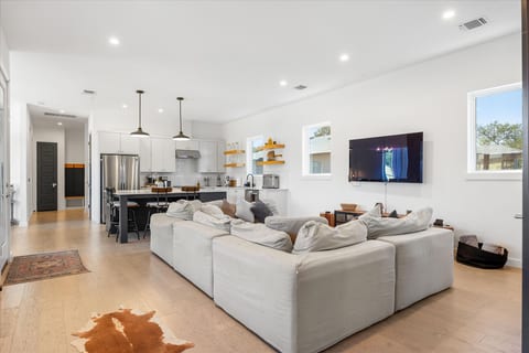 Bright open-plan living with oversized sectional and stylish modern kitchen
