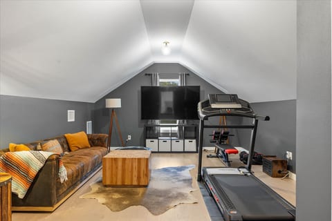 Cozy loft lounge with big-screen TV and private workout area