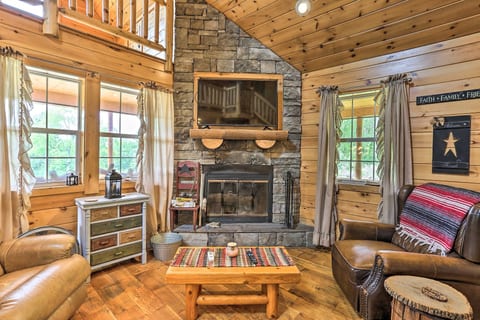 Cozy log cabin living room with stone fireplace and warm rustic charm