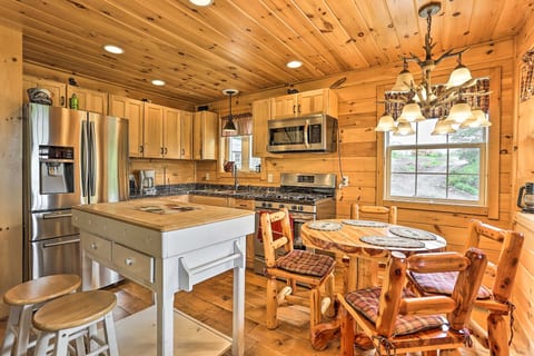 Cozy log-cabin kitchen with island seating and charming dining nook