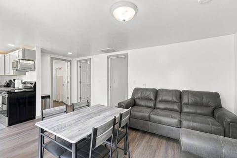 Bright open living space with dining for four and comfy sofa seating