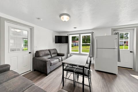 Bright living space with dining area, TV, and lovely natural light