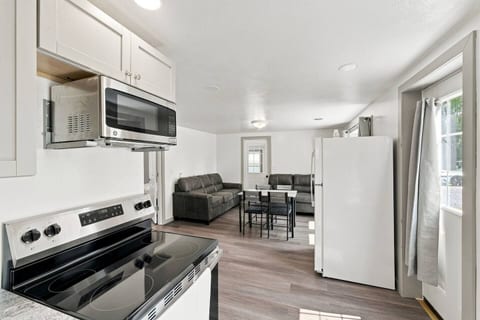 Bright open kitchen and living area with modern appliances and cozy seating