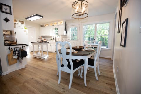 Bright farmhouse-style kitchen and dining area with natural light