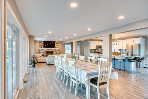 Spacious open-concept living with fireplace, dining for 8, and modern kitchen
