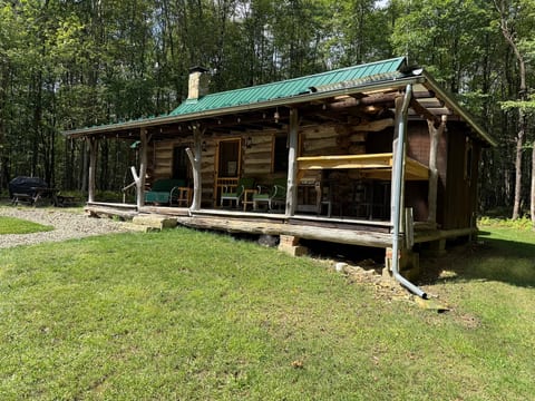 Rustic woodland cabin with spacious covered porch and outdoor seating