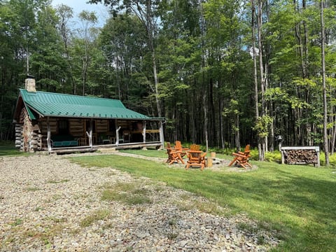 Cozy log cabin with fire pit, porch, and peaceful forest setting