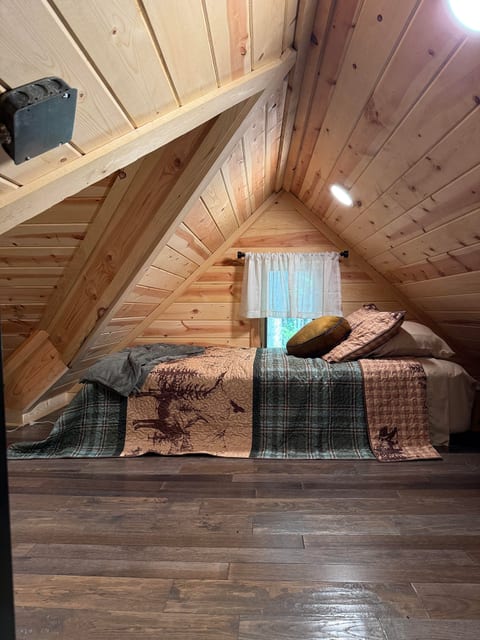 Cozy A-frame loft nook with rustic wood charm and inviting cabin vibes