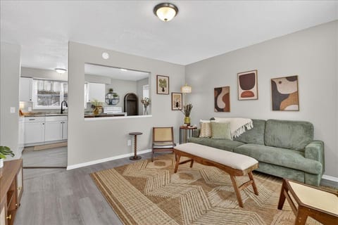 Cozy, stylish living room with open flow to the bright kitchen