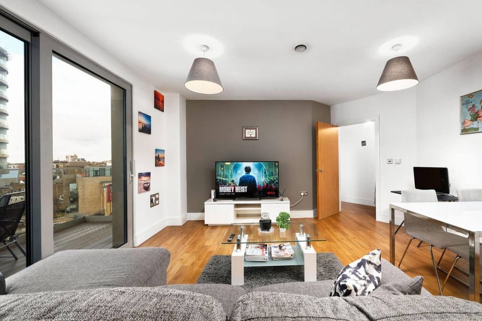 Bright open-plan living room with smart TV and dining area