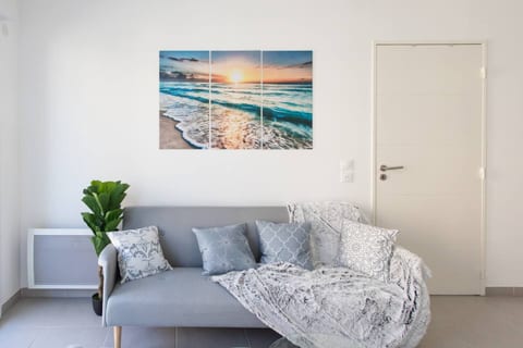 Bright living room with a comfortable sofa – opens onto the sunny balcony
