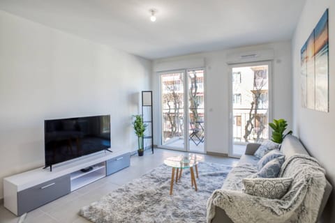 Living room with smart TV and large window onto the balcony