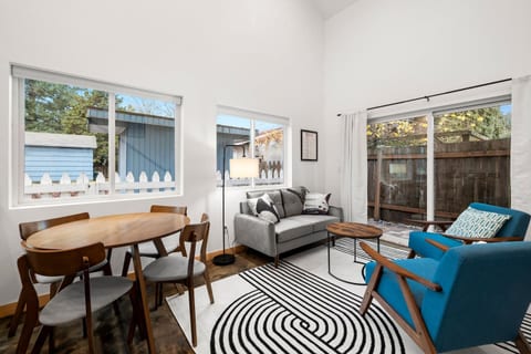 Living Room: Bright and airy, featuring chic furniture and a TV.