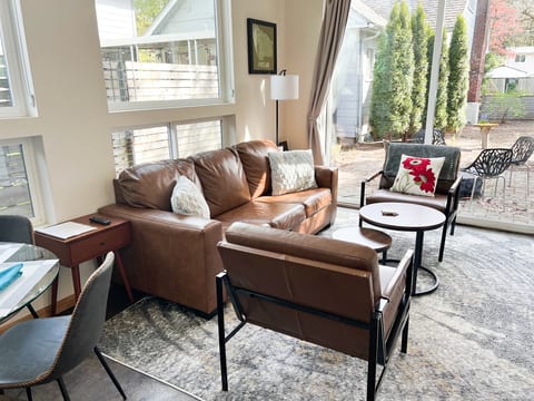 New Furniture! Living Room Retreat: Sunlit space with chic furnishings and garden views awaits your arrival!  Sofa is a queen pull out bed.