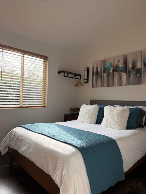 The bedroom suite in Dwell. Includes light-blocking shades, hangers for your clothes and a laundry machine.