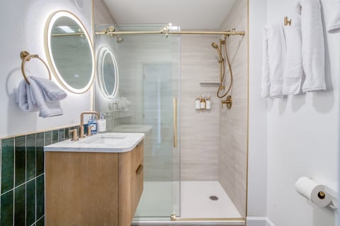 Spa-Like Bathroom: Enjoy a luxurious shower experience with sleek golden fixtures and chic decor! Shower has two shower heads!