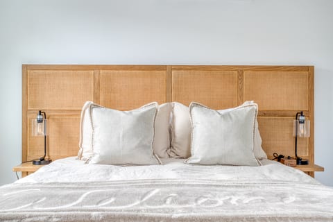 Bright Retreat: Modern bedroom with plush bedding, natural light, and chic decor for relaxation.