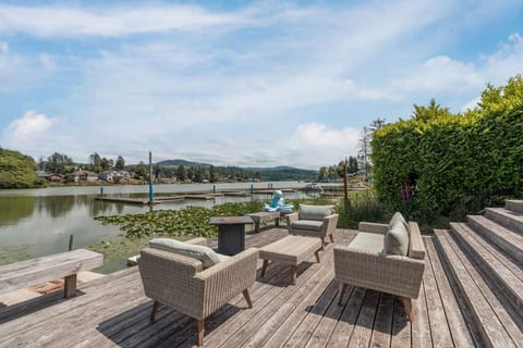 Deck Oasis: Enjoy serene lake views from stylish outdoor seating—perfect for sunrise coffee!