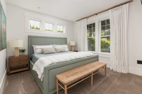 Downstairs Primary Suite: Relax in style with views, plush bedding, and a serene vibe.