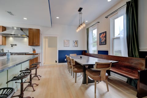 Large dining table sits 11-12 comfortably with additional seating for 4 at the island.