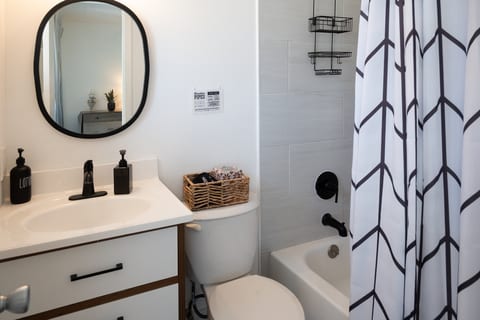 Bathroom with tub/shower combo, vanity and hotel-style toiletries