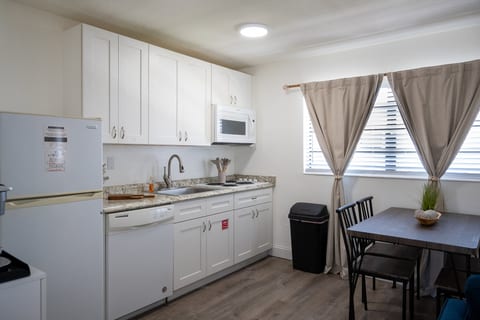 Full kitchen with dishwasher, full-size fridge and dining for four