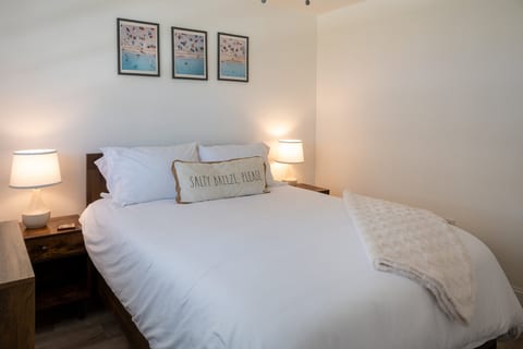 Coral House 2BR – Bedroom 1: plush queen bed with crisp hotel-quality linens – salty breeze, please