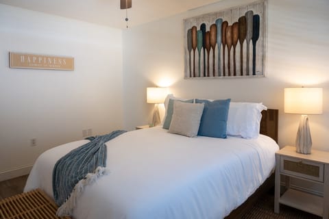 2BR – Bedroom 1: plush queen bed under the oars – happiness is a beach day