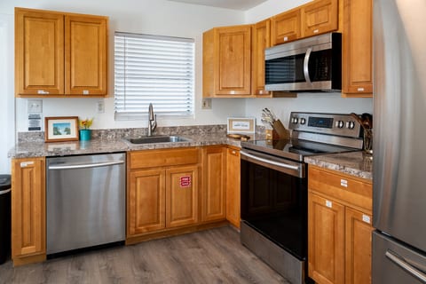 2BR – Full kitchen with stainless dishwasher, stove and microwave