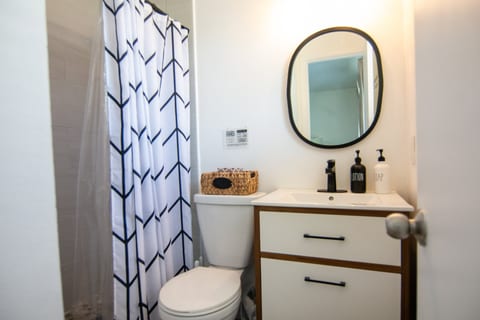 Modern bathroom with walk-in shower, modern vanity and hotel-style toiletries