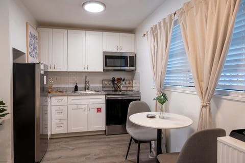 Kitchenette with stainless appliances and bistro dining table
