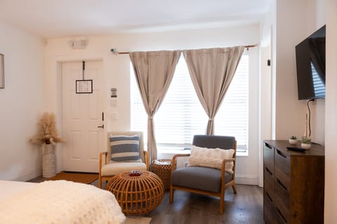 Cozy sitting area with armchairs, rattan accents and Smart TV