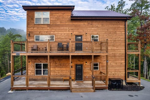 Fully paved roads lead to a flat, easy-access driveway with parking for five vehicles — a rare convenience for a private mountain cabin.