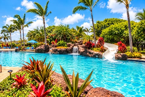 Tropical resort pool with waterslide, waterfalls & lush Kauai landscaping at the Poipu Beach Club.