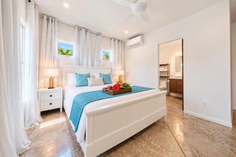 Bedroom 1 - Your private master retreat with ensuite bath, AC and tropical-inspired comfort.