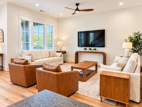 Bright, stylish living room with plush seating and large TV