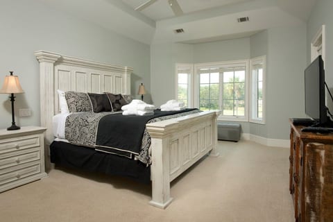 King bedroom with golf course view and balcony access