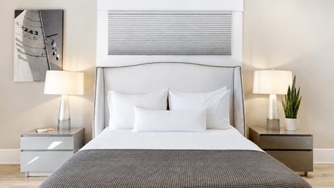 Wake up refreshed in the serene primary suite — queen bed, ensuite bath, and French doors to the backyard.