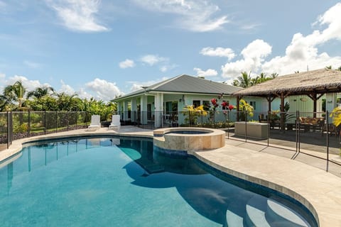 Resort style pool with 8 person hot tub view towards Hilo side house with Tiki relaxing area in background on rt side.
Eco-friendly tropical retreat near Hilo with gardens, nature, and coastal beauty.
Private oceanfront cottage on Hawaii's Big Isle