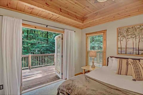 Throw open the doors and let the forest in. A serene, light-filled bedroom retreat at Owl's Rest, your North Georgia cabin escape in Ellijay, GA.