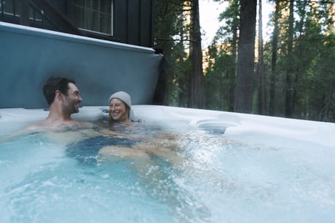 Relax in your own private hot tub surrounded by a peaceful forest.