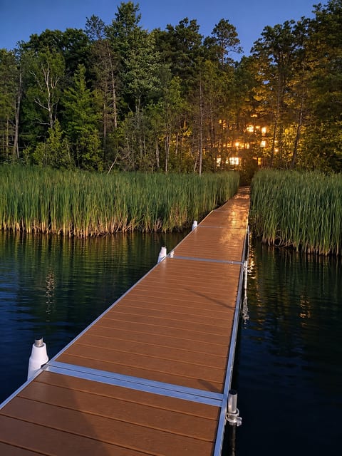 Dock at night view of 3 story cabin at night.
