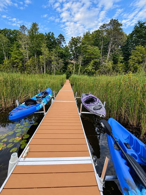 Private dock with kayaks looking at the house.