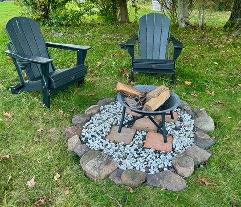 Cozy backyard fire pit with Adirondack chairs for relaxing evenings