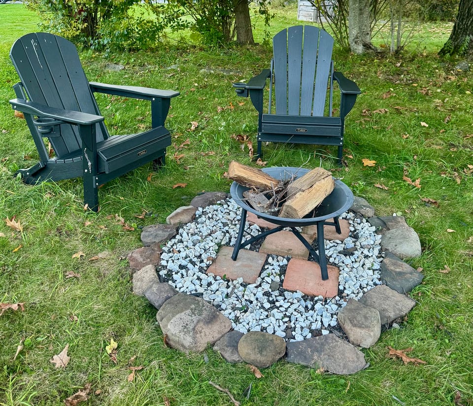 Cozy backyard fire pit with Adirondack chairs for relaxing evenings