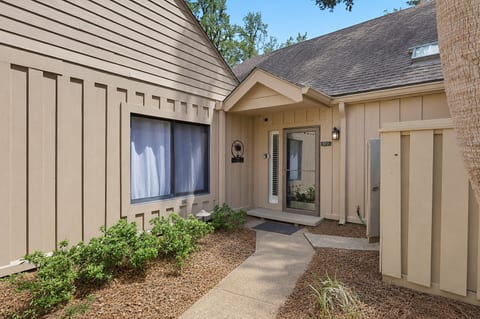 Private villa entrance with landscaped walkway and welcoming covered entry